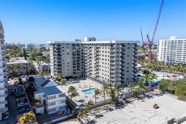 a room with stainless steel appliances kitchen island granite countertop a sink and cabinets