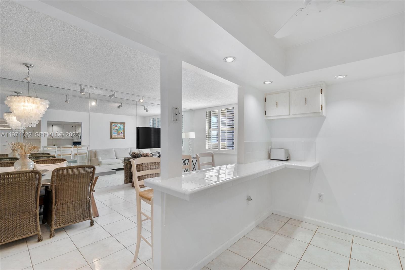 9273 Collins Avenue, Unit 901 Surfside, FL 33154 - Photo 3 of 24 a room with stainless steel appliances kitchen island granite countertop a sink and cabinets