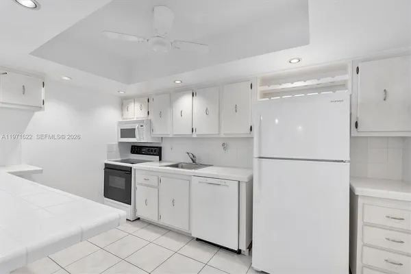 a kitchen with granite countertop a sink and a stove top oven