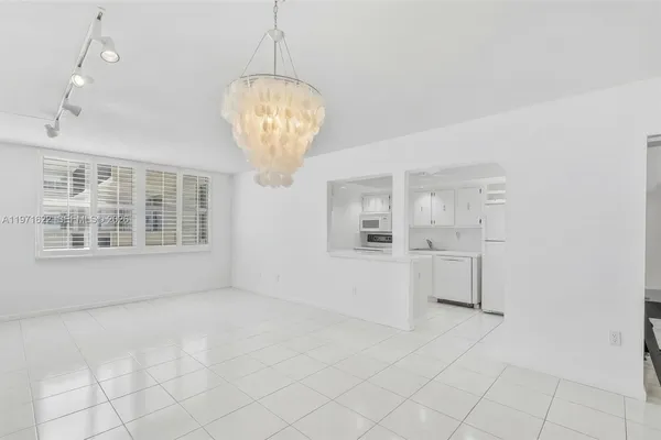 a view of a dining room with furniture wooden floor and chandelier