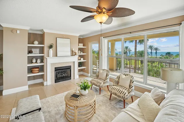 a living room with furniture fireplace and a large window