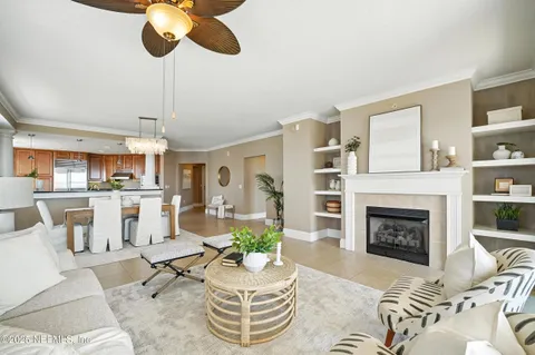 a living room with furniture fireplace and a chandelier