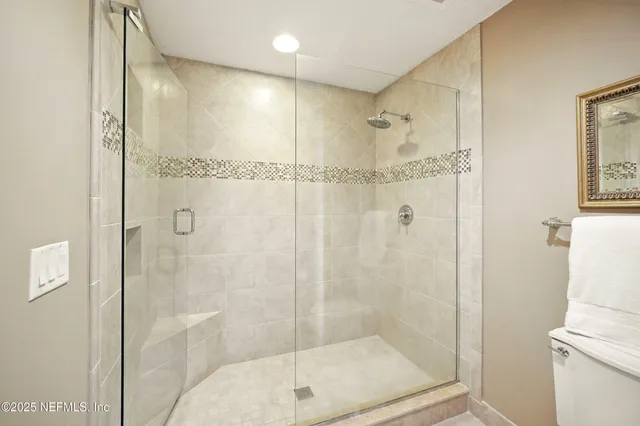 a bathroom with a glass shower door