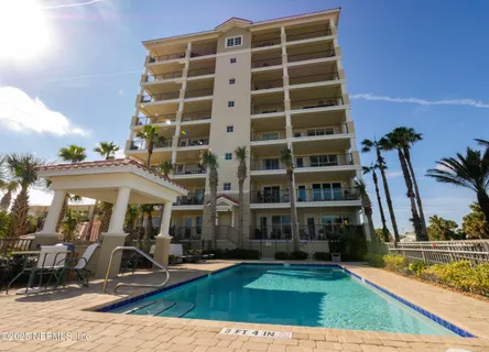 a view of a house with swimming pool and sitting area
