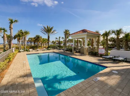 a view of a swimming pool with outdoor seating