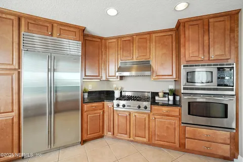 a kitchen with white cabinets stainless steel appliances and a sink