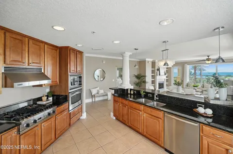 a kitchen with stainless steel appliances a sink stove and cabinets