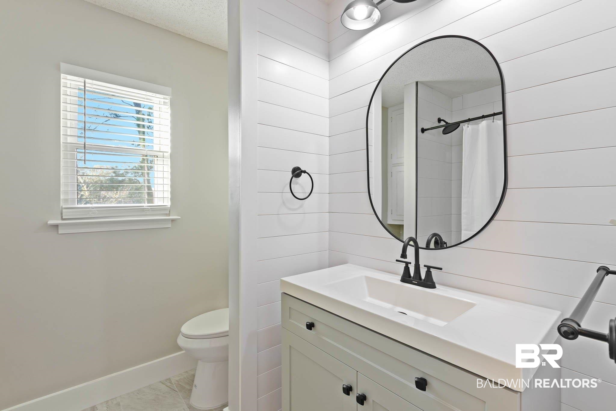 608 Southern Way Daphne, AL 36527 - Photo 24 of 35 Full bath with vanity, a shower with curtain, wood walls, and a textured ceiling