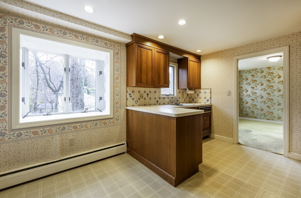 41 Squire Road Winchester, MA 01890 - Photo 12 of 25 a bathroom with a double vanity sink a mirror and a bathtub