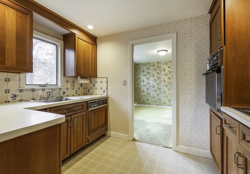41 Squire Road Winchester, MA 01890 - Photo 13 of 25 a bathroom with a granite countertop sink a mirror and a shower