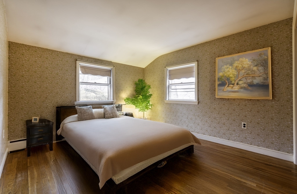 41 Squire Road Winchester, MA 01890 - Photo 19 of 25 a bedroom with a bed and wooden floor