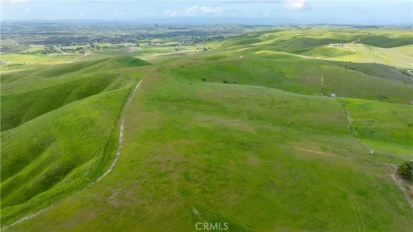 a view of a field with an ocean
