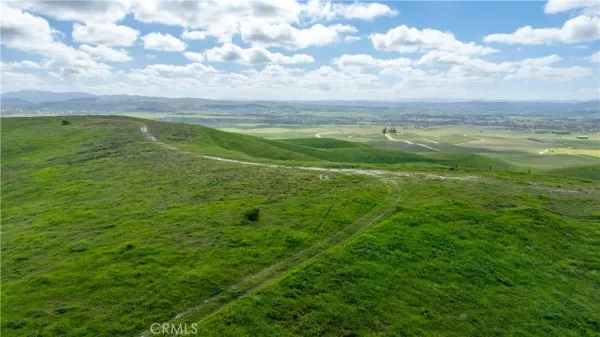 a view of a field with an ocean view