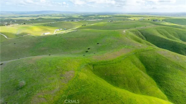 a view of a field with an ocean beach