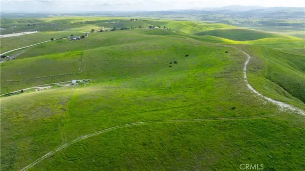 a view of a field with an ocean
