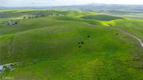 a view of a field with an ocean