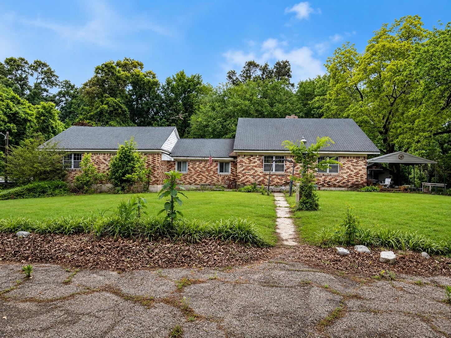 7280 Walsh Road Millington, TN 38053 - Photo 1 of 34 Brick exterior residence featuring a dark shingle roof and white-framed windows