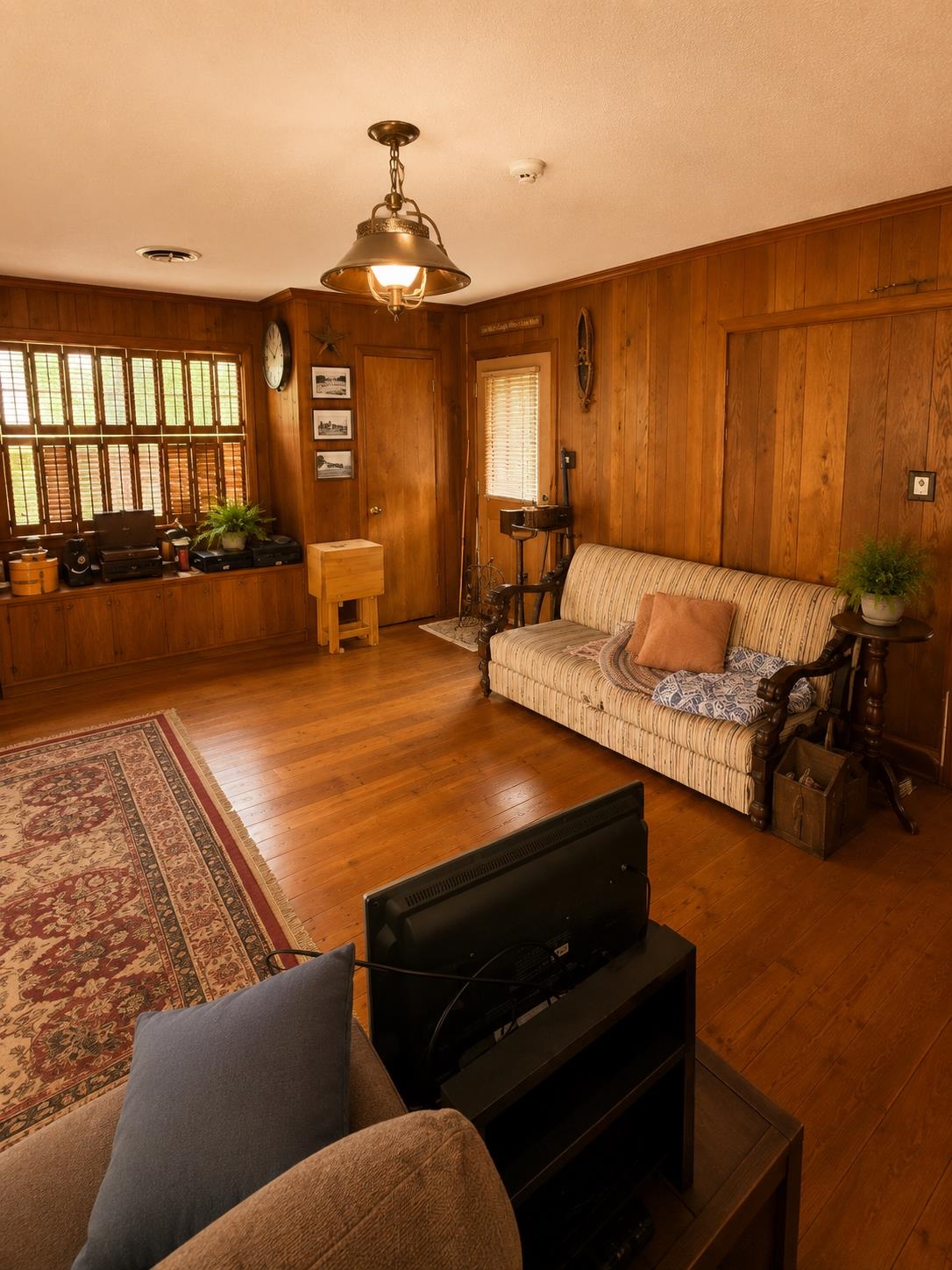 7280 Walsh Road Millington, TN 38053 - Photo 11 of 34 Interior room featuring wood-finish flooring, wood paneling, and a unique window treatment with multiple small louvered panels