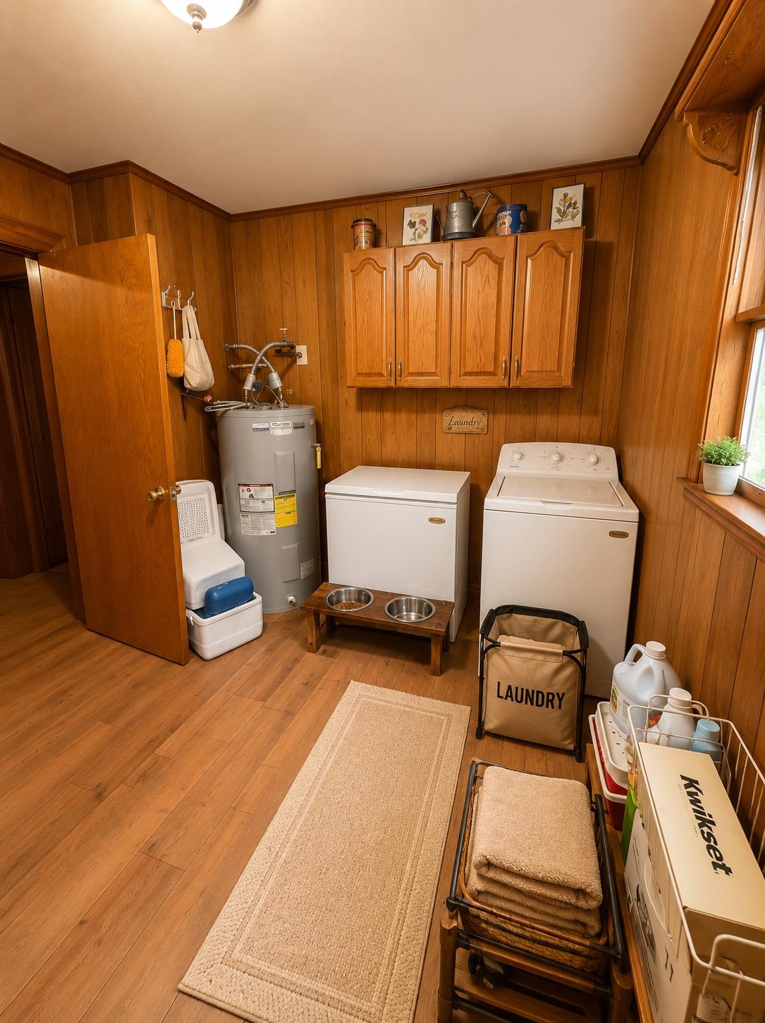 7280 Walsh Road Millington, TN 38053 - Photo 12 of 34 Dedicated laundry area featuring wood-finish flooring, paneled walls, and overhead cabinetry