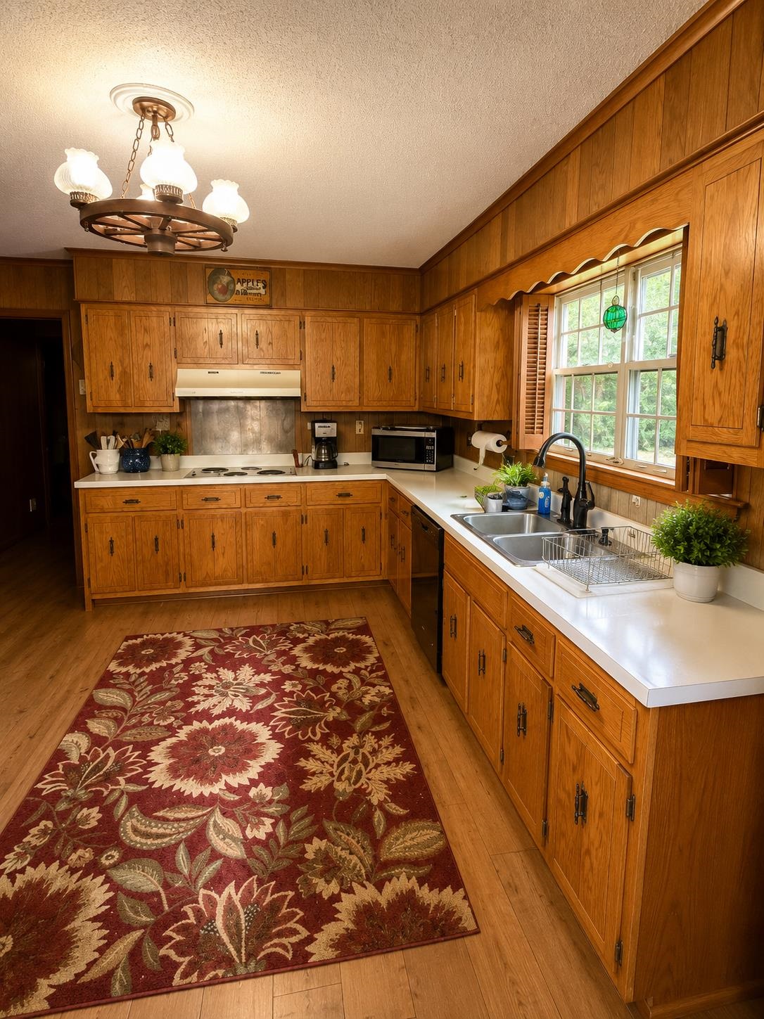 7280 Walsh Road Millington, TN 38053 - Photo 2 of 34 Kitchen featuring wood-finish flooring, abundant wood cabinetry, white countertops, a double basin sink with a black gooseneck faucet, and a window providing natural light