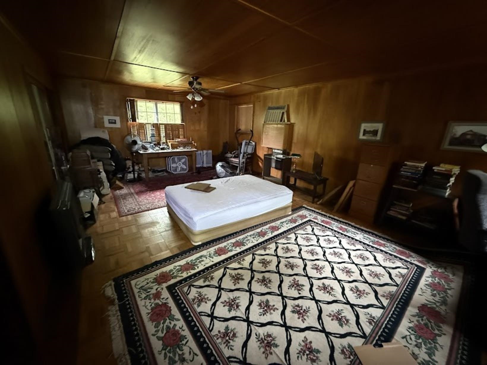 7280 Walsh Road Millington, TN 38053 - Photo 26 of 34 Room featuring extensive wood paneling, wood-finish flooring, and a ceiling fan with integrated lighting