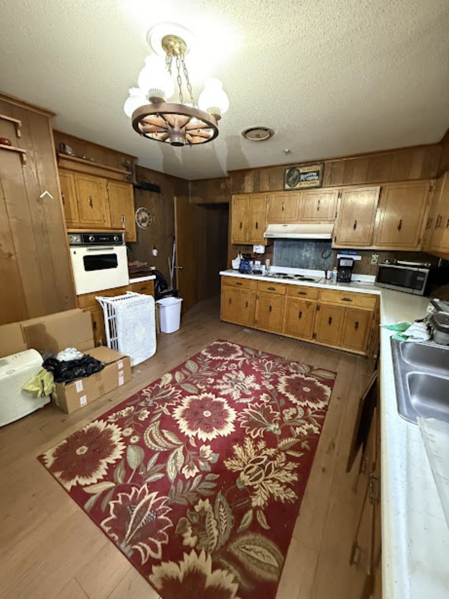 7280 Walsh Road Millington, TN 38053 - Photo 5 of 34 Kitchen featuring extensive wood-finish cabinetry, built-in oven, and wood-paneled walls