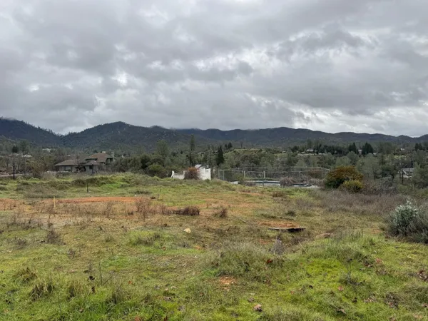 a view of a town with mountains in the background