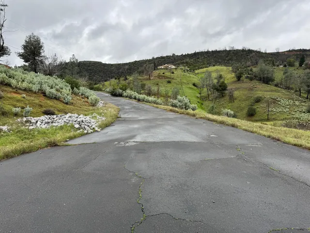 a view of a road with mountains in the background