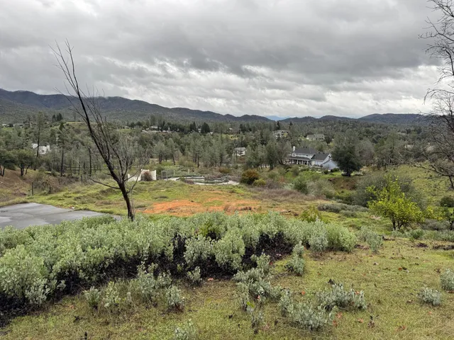 a view of mountain with green field