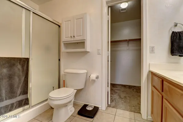 a white toilet sitting next to a bathroom sink