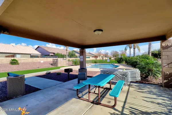 a view of a swimming pool and outdoor seating