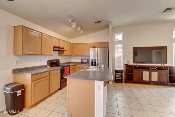 a kitchen with stainless steel appliances a stove refrigerator sink and microwave
