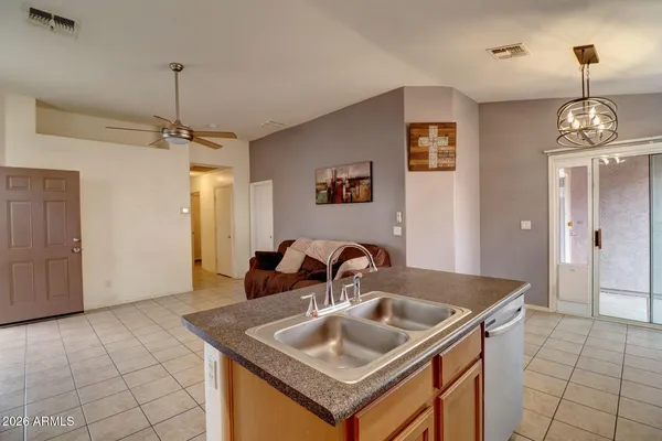 a kitchen with a sink a counter space and cabinets