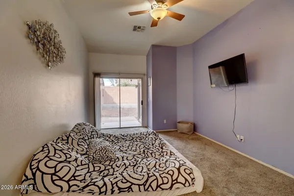 a bedroom with a bed and a flat screen tv