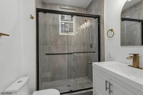 a bathroom with a shower a toilet and a sink