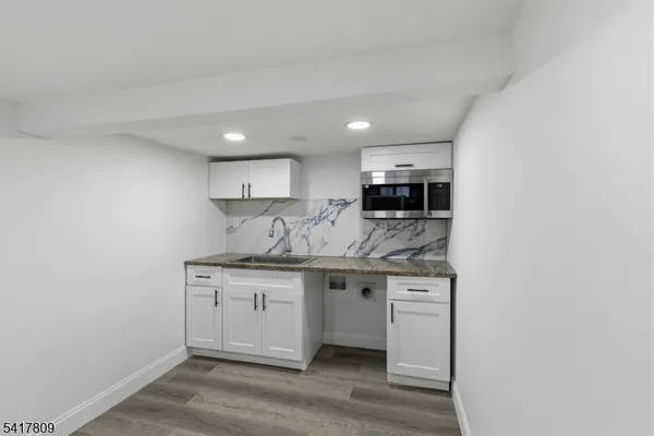 a kitchen with stainless steel appliances granite countertop a sink and a stove