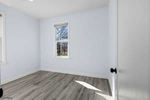 an empty room with wooden floor and closet