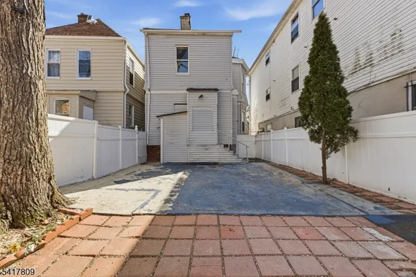 a view of a yard with wooden fence