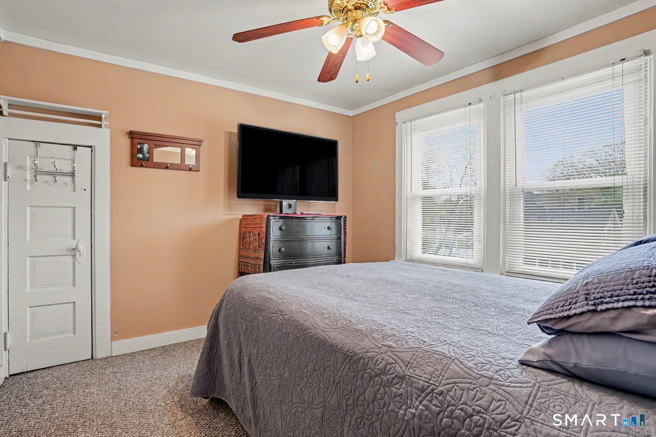 74 Maple Street Seymour, CT 06483 - Photo 21 of 40 a bedroom with a bed and a flat screen tv