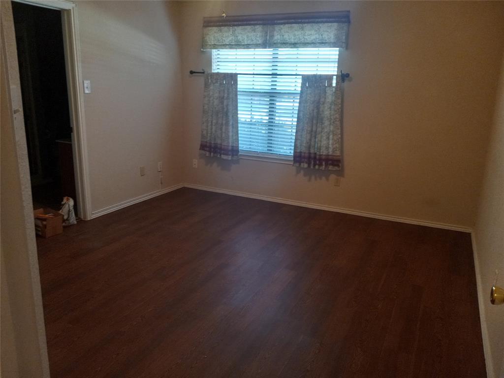 557 Grace Coppell, TX 75019 - Photo 20 of 22 an empty room with wooden floor and windows