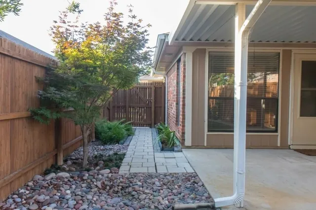 a view of a pathway besides a house
