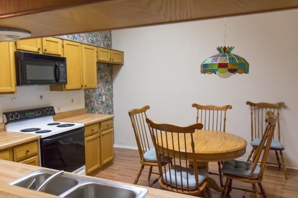 557 Grace Coppell, TX 75019 - Photo 7 of 22 a kitchen with stainless steel appliances a dining table chairs and a refrigerator