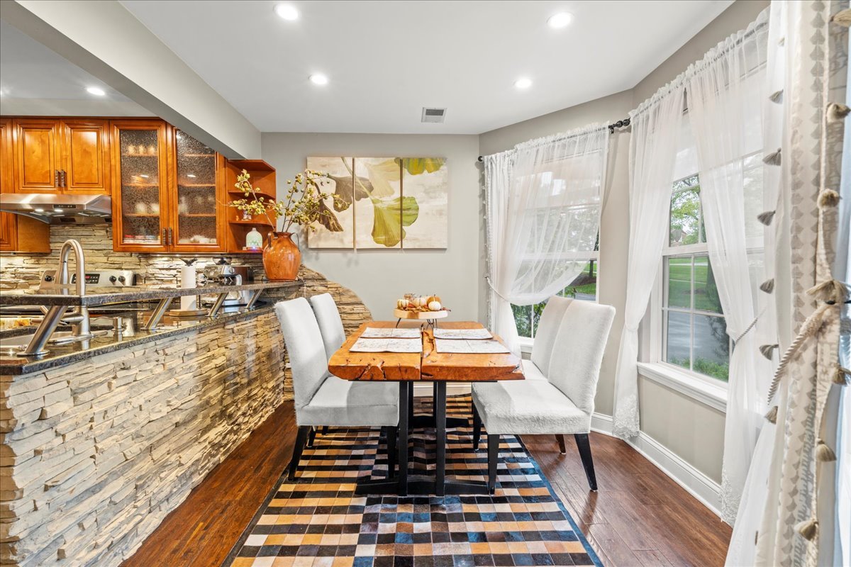 8025 Barrymore Drive Darien, IL 60561 - Photo 11 of 31 a dining room with furniture a rug and wooden floor