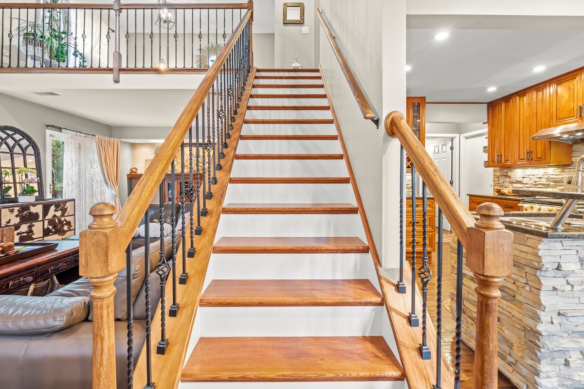 8025 Barrymore Drive Darien, IL 60561 - Photo 15 of 31 a view of staircase with lots of frames on wall and windows