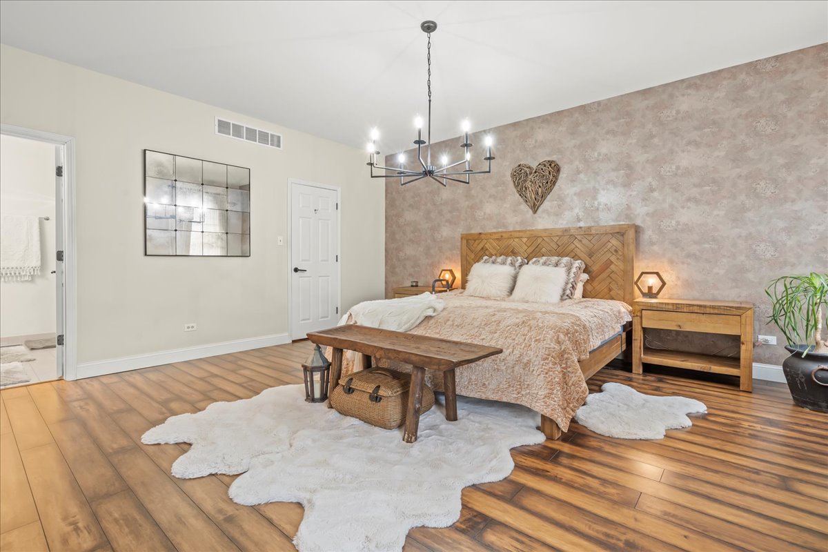 8025 Barrymore Drive Darien, IL 60561 - Photo 17 of 31 a bedroom with furniture and a chandelier