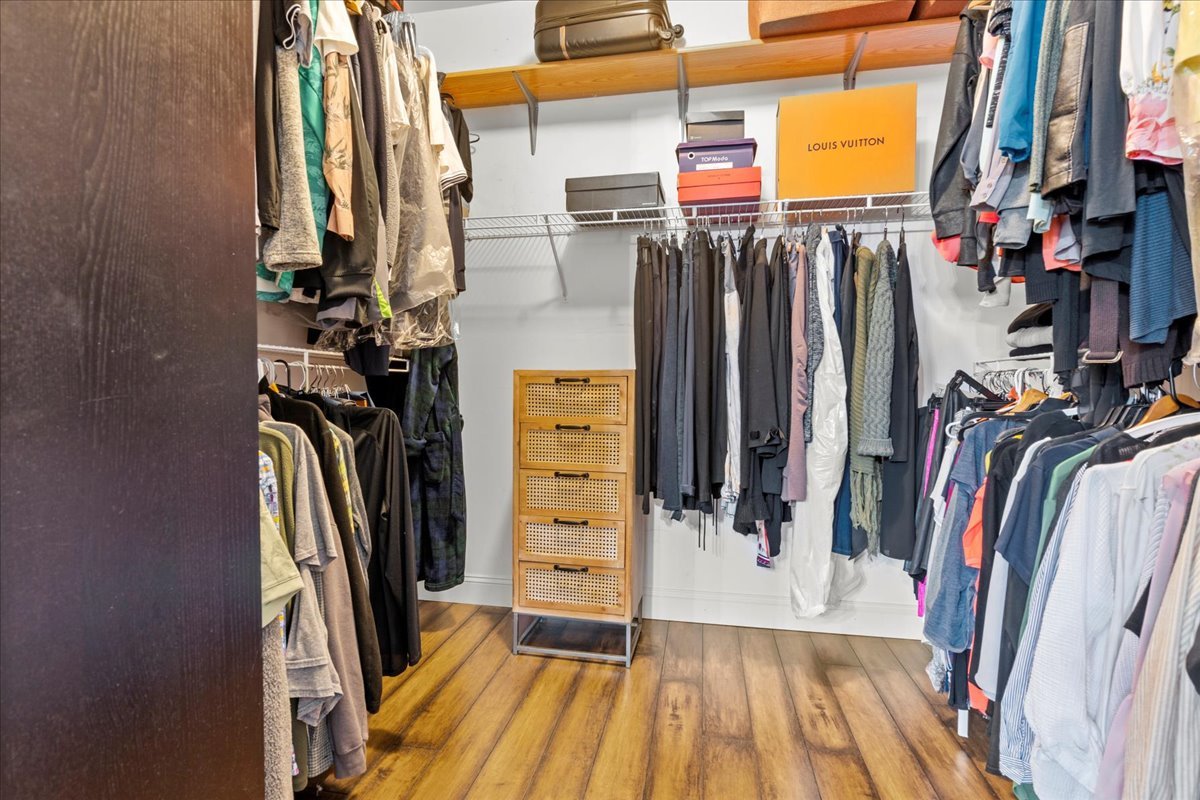 8025 Barrymore Drive Darien, IL 60561 - Photo 18 of 31 a view of walk in closet with clothes