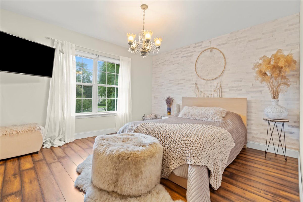 8025 Barrymore Drive Darien, IL 60561 - Photo 20 of 31 a bedroom with a bed mirror and window