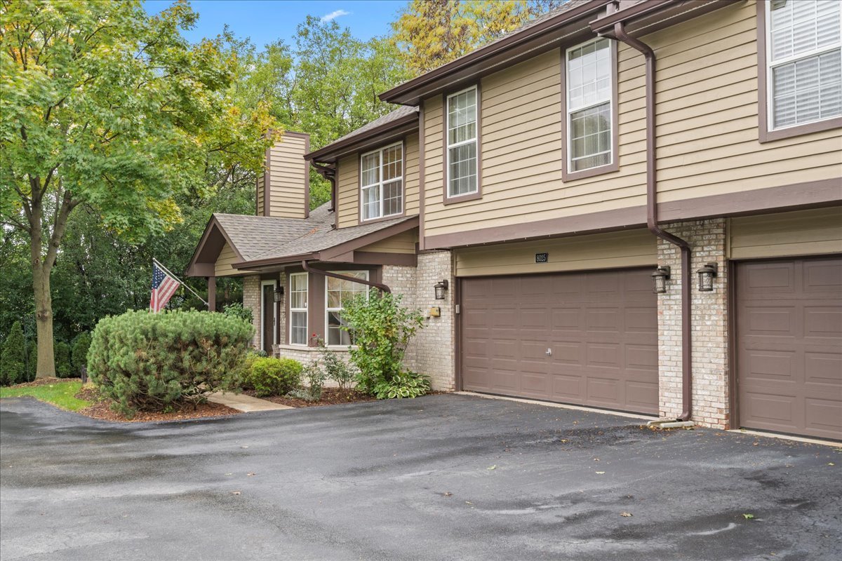 8025 Barrymore Drive Darien, IL 60561 - Photo 29 of 31 a front view of a house with a yard and garage