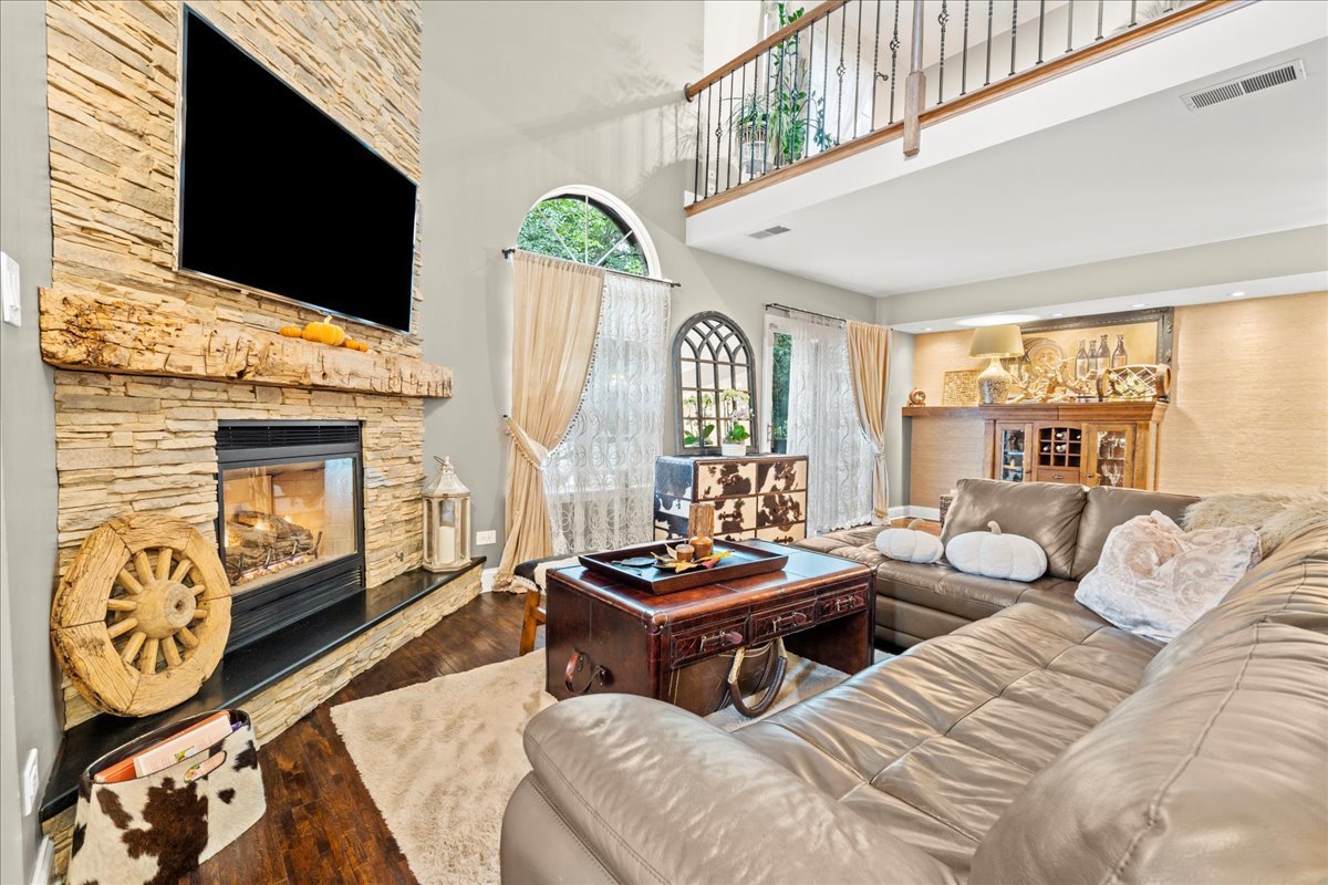 8025 Barrymore Drive Darien, IL 60561 - Photo 4 of 31 a living room with furniture a flat screen tv and a fireplace