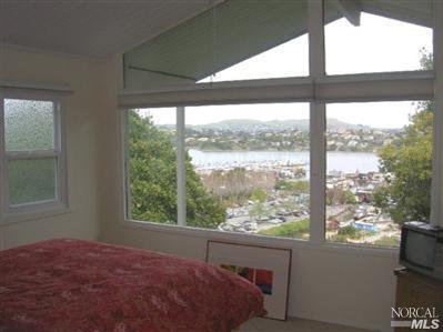 10 Ross Road Sausalito, CA 94965 - Photo 4 of 6 a bed sitting in a bedroom next to a window
